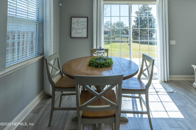 dining area featuring baseboards and wood finished floors