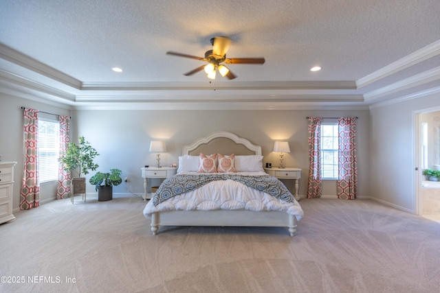 bedroom featuring a raised ceiling, light colored carpet, and ornamental molding