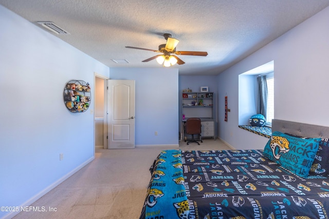 unfurnished bedroom with baseboards, carpet, visible vents, and a textured ceiling