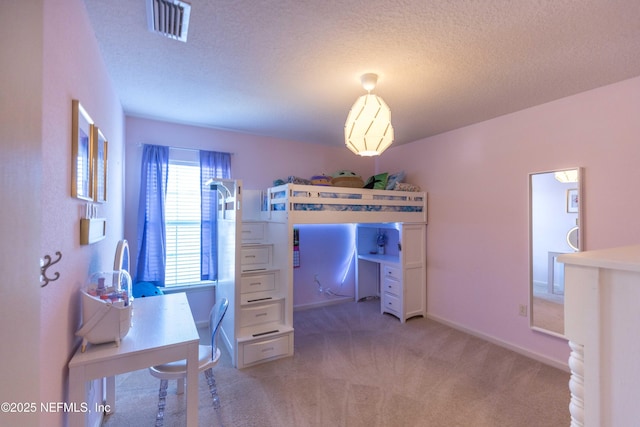 bedroom featuring visible vents, light colored carpet, a textured ceiling, and baseboards