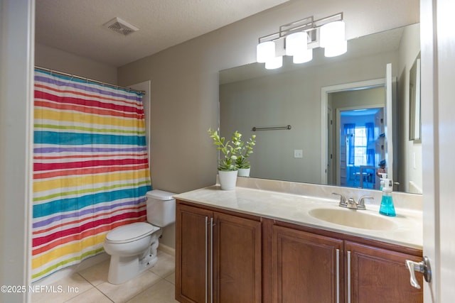 bathroom with visible vents, toilet, a textured ceiling, tile patterned flooring, and vanity