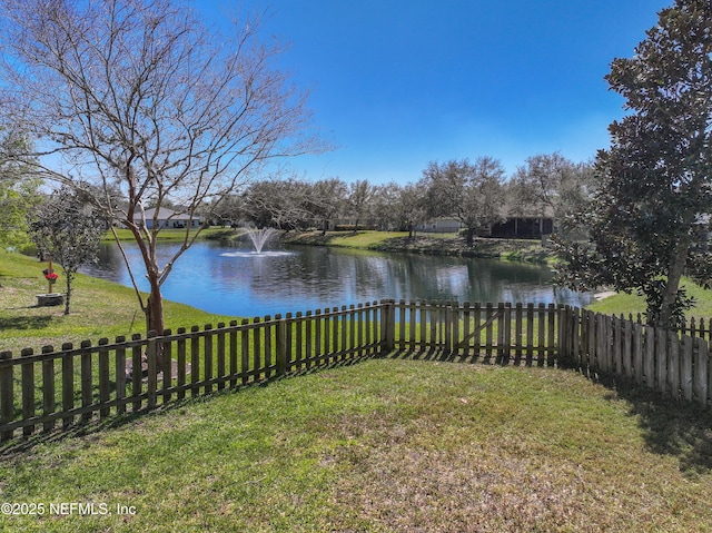 view of yard with fence and a water view