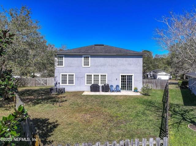 rear view of house featuring stucco siding, central air condition unit, a lawn, a fenced backyard, and a patio area