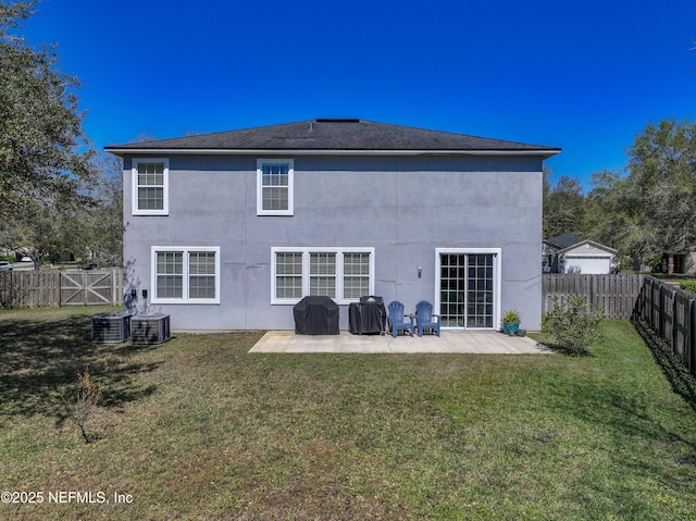 rear view of house with stucco siding, a lawn, a patio, a fenced backyard, and cooling unit