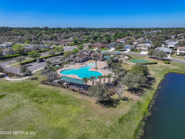 drone / aerial view featuring a residential view and a water view