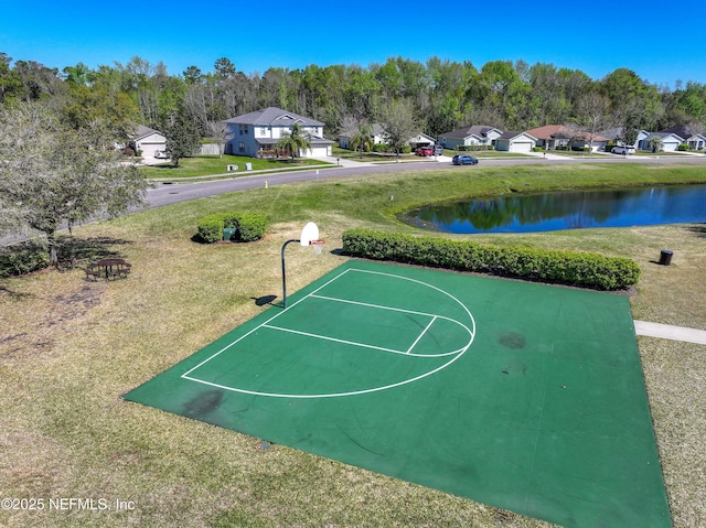 view of sport court featuring a water view, a lawn, and community basketball court