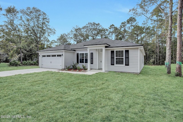 view of front of home with a front lawn, concrete driveway, and a garage