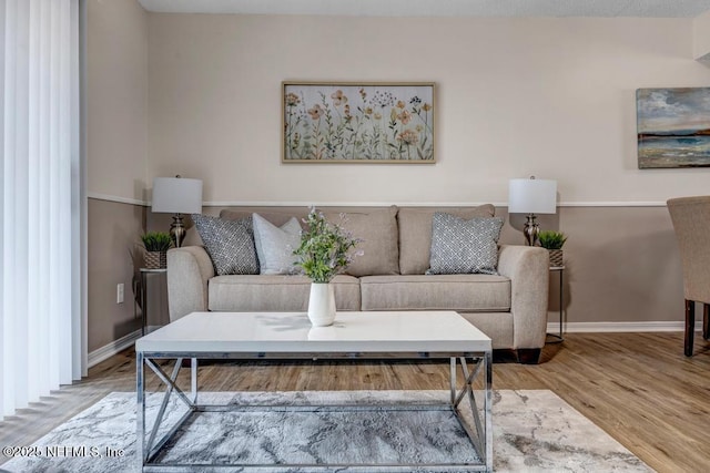 living room with wood finished floors and baseboards