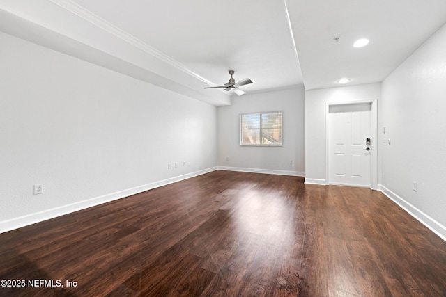 spare room featuring dark wood-style floors, recessed lighting, ceiling fan, and baseboards