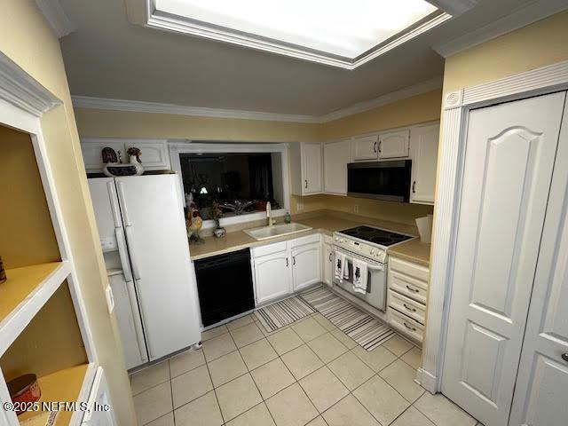 kitchen featuring crown molding, light countertops, white appliances, white cabinetry, and a sink