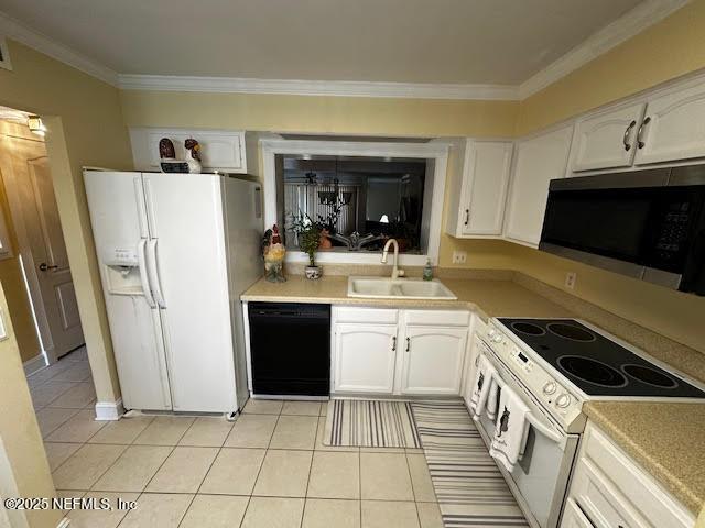 kitchen with a sink, white appliances, light countertops, and white cabinetry