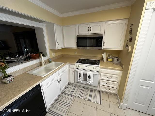 kitchen featuring stainless steel microwave, dishwasher, ornamental molding, white range with electric stovetop, and a sink