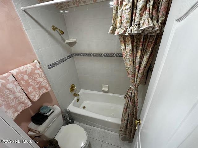 full bathroom with toilet, tile patterned flooring, and shower / bath combination with curtain