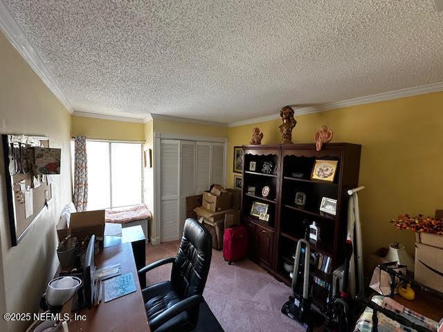 office area with carpet floors, a textured ceiling, and crown molding