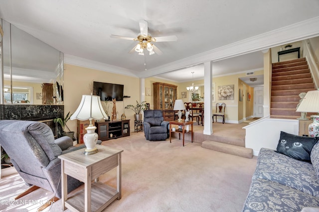 living area featuring stairway, visible vents, light carpet, crown molding, and ceiling fan with notable chandelier