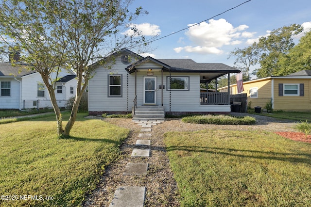 view of front of house with a front lawn and fence