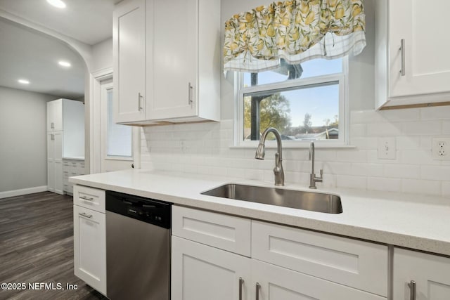 kitchen with a sink, white cabinetry, decorative backsplash, and stainless steel dishwasher