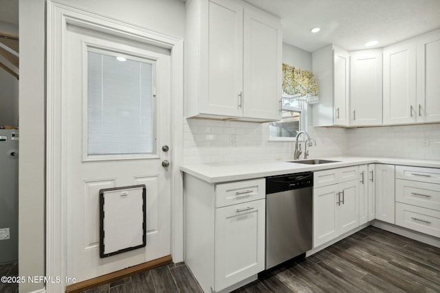 kitchen with stainless steel dishwasher, dark wood finished floors, white cabinetry, and a sink