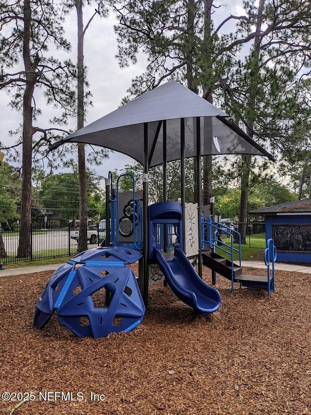 communal playground featuring fence