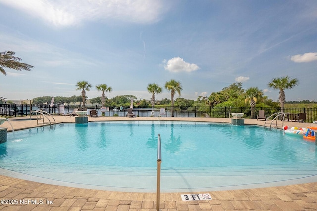 pool featuring a patio and fence