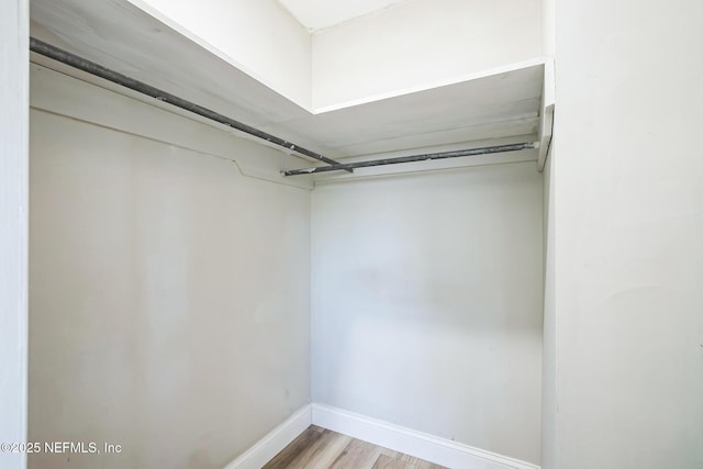 spacious closet with light wood finished floors