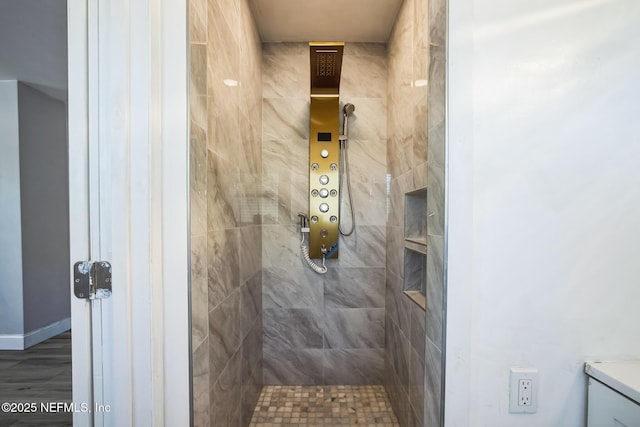 bathroom with a tile shower