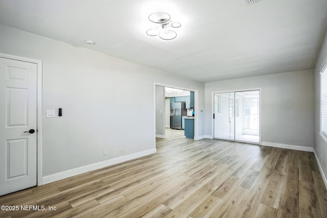 interior space featuring light wood-type flooring and baseboards