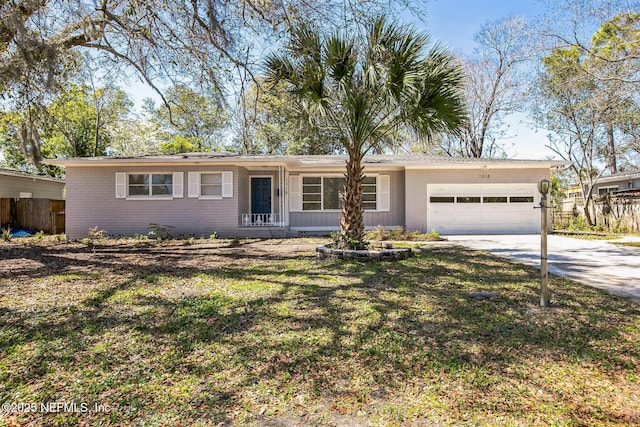 ranch-style house featuring an attached garage, fence, brick siding, and driveway