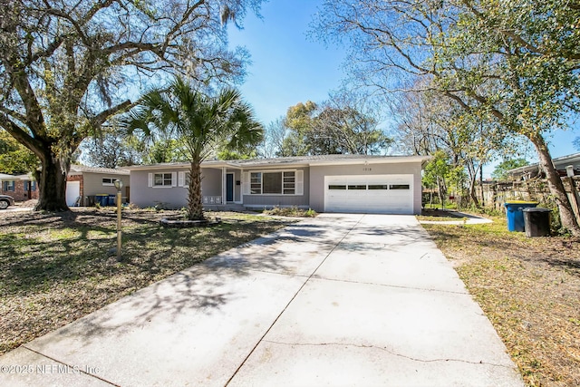 ranch-style home with driveway, a front yard, and a garage