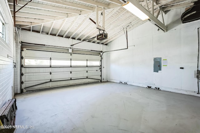 garage with electric panel and a garage door opener