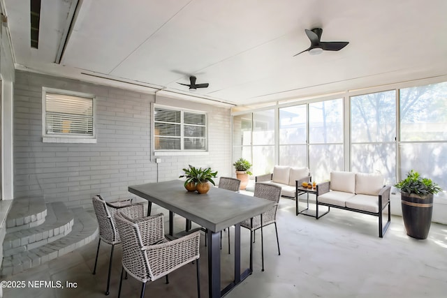 sunroom featuring a ceiling fan