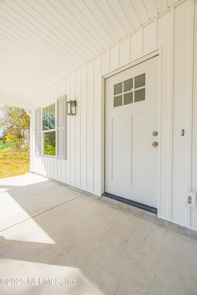 doorway to property featuring board and batten siding