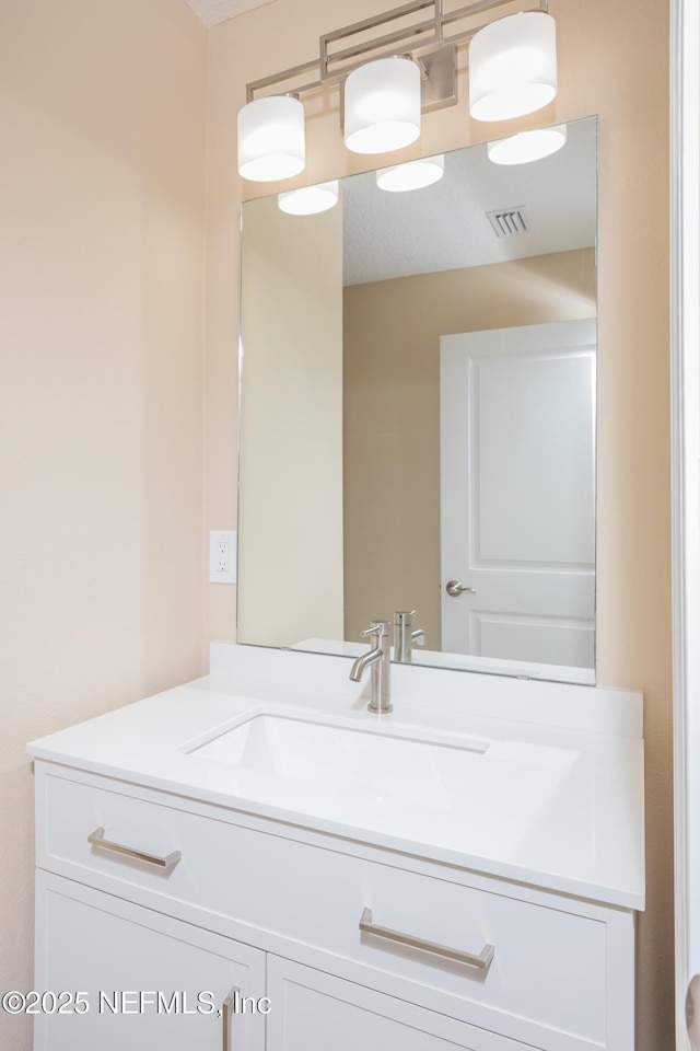 bathroom with visible vents and vanity