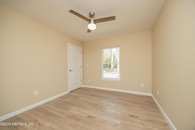 unfurnished room with light wood-style flooring, baseboards, and ceiling fan