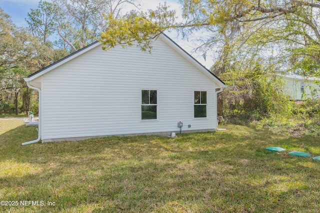 view of side of property with a yard