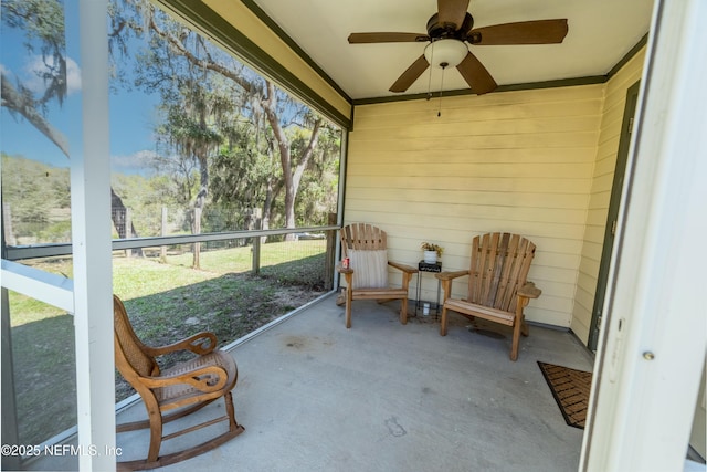 sunroom / solarium featuring ceiling fan