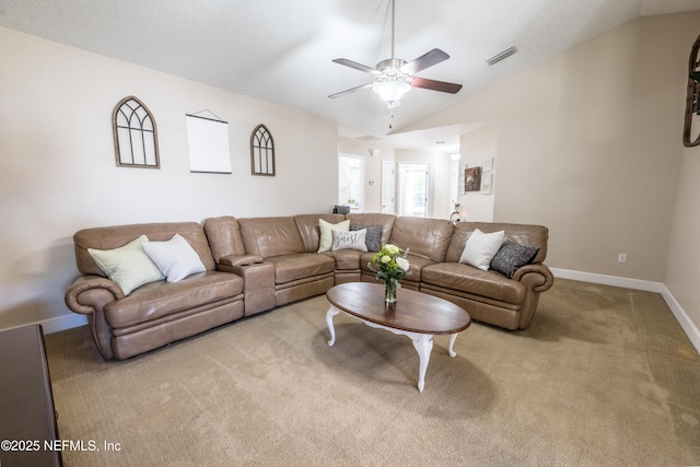 carpeted living room featuring vaulted ceiling, baseboards, visible vents, and ceiling fan