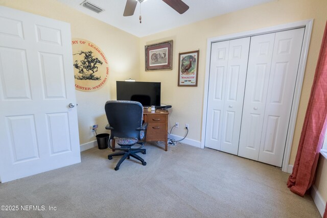 office featuring visible vents, a ceiling fan, baseboards, and carpet floors