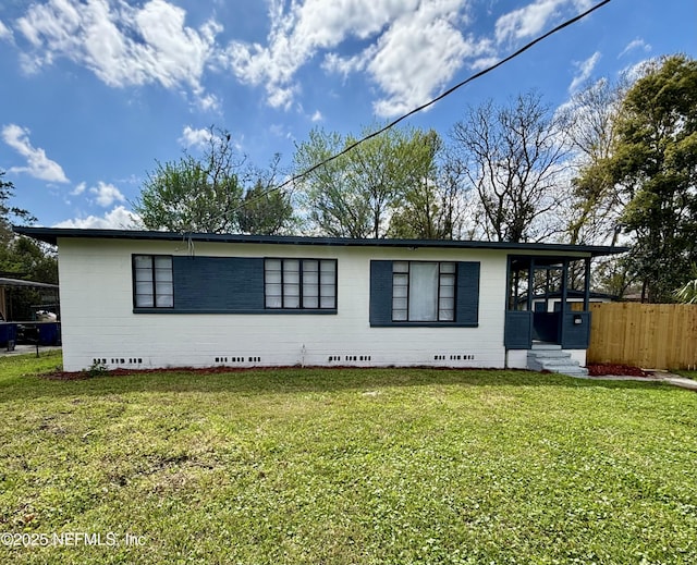 exterior space with crawl space, a front yard, and fence