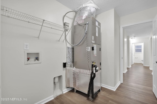 washroom with wood finished floors, baseboards, laundry area, washer hookup, and a textured ceiling