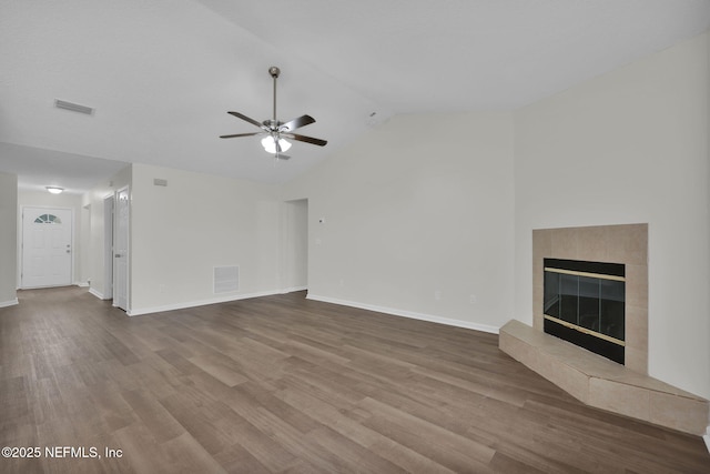 unfurnished living room with visible vents, a fireplace, and wood finished floors