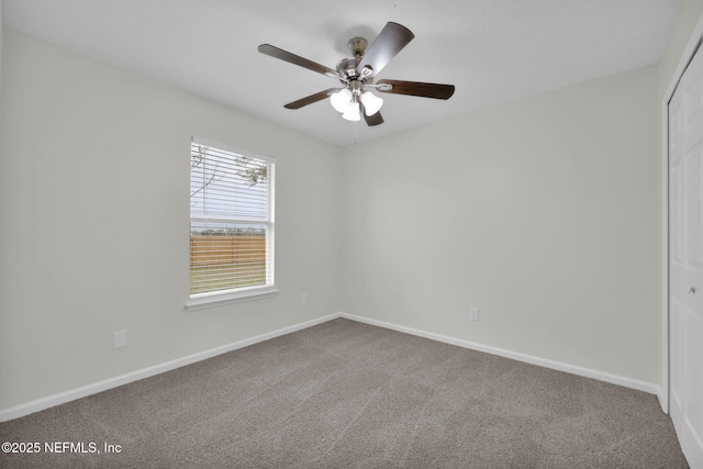 unfurnished room with ceiling fan, baseboards, and carpet floors