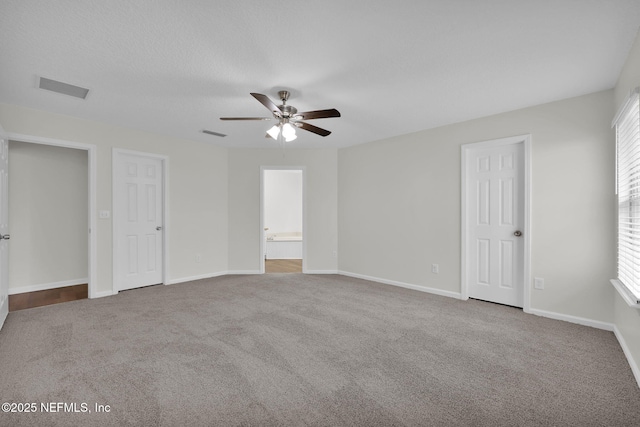 unfurnished bedroom featuring visible vents, ensuite bathroom, baseboards, and carpet floors