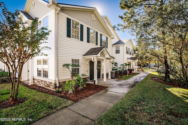 view of front of property featuring central AC and a front lawn