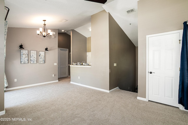 empty room with light carpet, visible vents, baseboards, and lofted ceiling