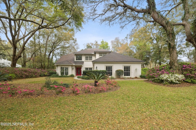 exterior space featuring a front lawn and stucco siding