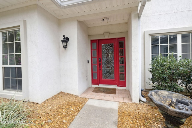 entrance to property featuring stucco siding