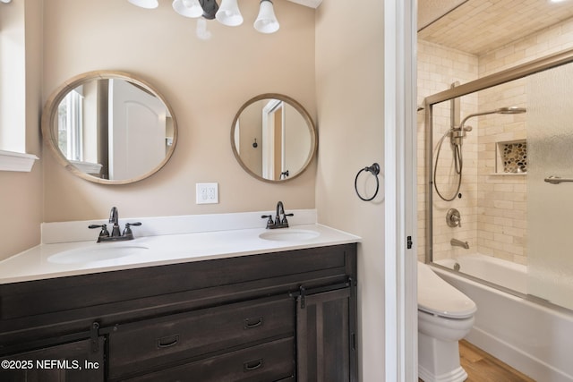 bathroom featuring double vanity, toilet, bathing tub / shower combination, and a sink