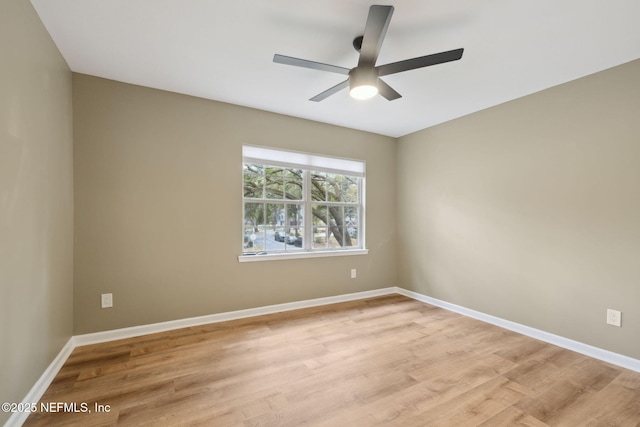 empty room featuring light wood finished floors, ceiling fan, and baseboards