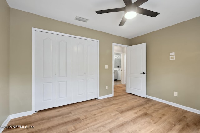 unfurnished bedroom with visible vents, baseboards, wood finished floors, a closet, and a ceiling fan